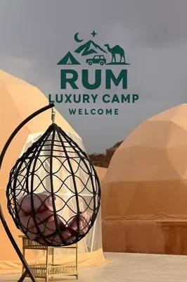 a bed in a cage in front of two tents at RUM LUXURY CAMp in Wadi Rum