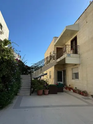 a building with a staircase and a balcony at Ayyash in Amman