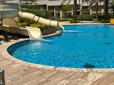 a water slide in a pool in a resort at Alraha village-aqaba قرية الراحة- مرسى زايد -العقبة in Aqaba