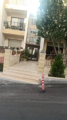 a building with a staircase in front of a building at Elegant Apartment in Amman