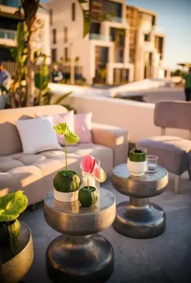 a couple of tables with plants on top of them at Modern Apartment In Ayla in Aqaba