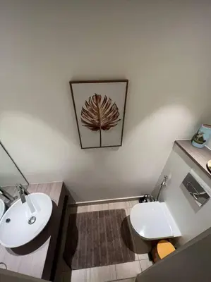a bathroom with a white toilet and a sink at Modern Apartment In Ayla in Aqaba