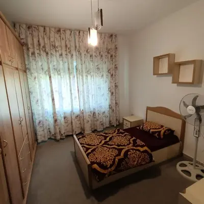 a bedroom with a bed and a window with curtains at Said in Amman