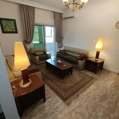 a living room with a couch and a table at Said in Amman