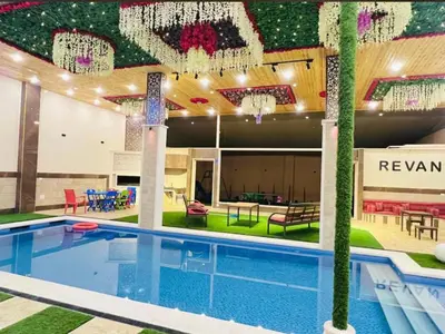 a swimming pool in a large building with a pool at مزرعة ريفان in Dawqarah