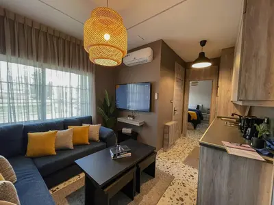 a living room with a blue couch and a table at Hawari Group in Amman
