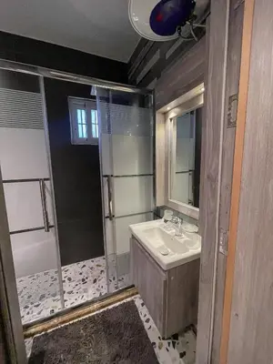 a bathroom with a sink and a shower at Hawari Group in Amman