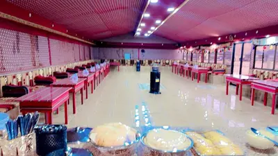 a large banquet hall with tables and red tables at Dream Bedouin Life Camp Wadi Rum in Disah