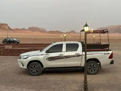 a white truck parked next to a street light at Dream Bedouin Life Camp Wadi Rum in Disah