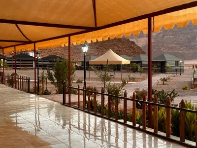 a building with a fence and plants in a courtyard at Dream Bedouin Life Camp Wadi Rum in Disah