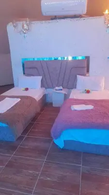 a bedroom with two beds and a tile floor at Mountain star in Disah