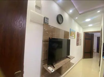 a living room with a flat screen tv on a wall at الأردن عمان ضاحية الأمير راشد شارع مكه in Umm Uthainah