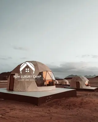 a museum with two domes in the desert at rum luxury camp in Wadi Rum