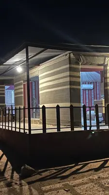 a fence in front of a building at night at Rum Moon Camp in Wadi Rum