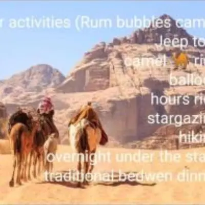 a picture of two camels walking in the desert at Rum Moon Camp in Wadi Rum