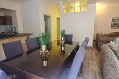 a living room with a table and a couch at Peppermint AL Weibdeh 1-Bed Cozy Apartment in Ash Shumaysānī