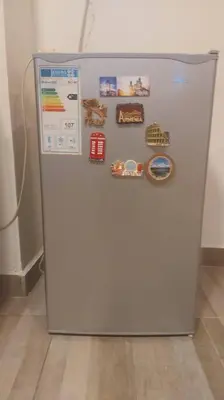 a white refrigerator with magnets on the side of it at Peppermint AL Weibdeh 1-Bed Cozy Apartment in Ash Shumaysānī