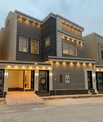 a large black house with lights on top of it at شقه سياحيه أبو نصير in Ţāb Kirā‘