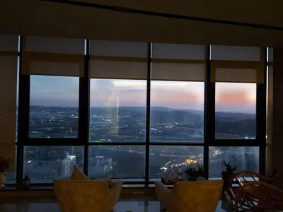 a view of a city from a large window at Villa rose 3 in Khirbat Abū Ḩāmid