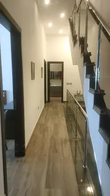 a hallway with a staircase in a house with a room at Villa rose 3 in Khirbat Abū Ḩāmid
