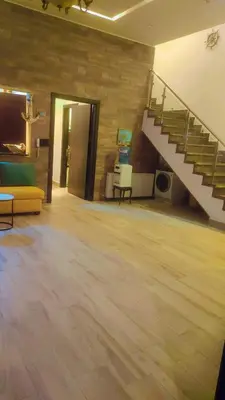a large room with a staircase and a wooden floor at Villa rose 3 in Khirbat Abū Ḩāmid