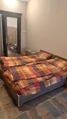 a bed with a quilt on it in a bedroom at أبو راشد للشقق المفروشه in Aqaba
