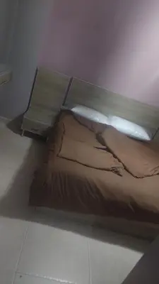 a bed sitting in a room with avertisement at أبو راشد للشقق المفروشه in Aqaba