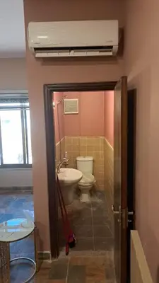a bathroom with a toilet and a sink at أبو راشد للشقق المفروشه in Aqaba