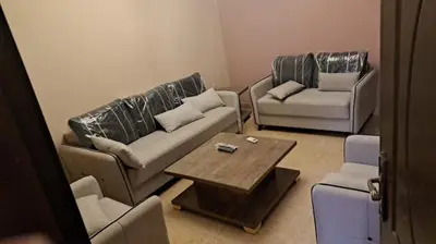 a living room with two couches and a coffee table at أبو راشد للشقق المفروشه in Aqaba