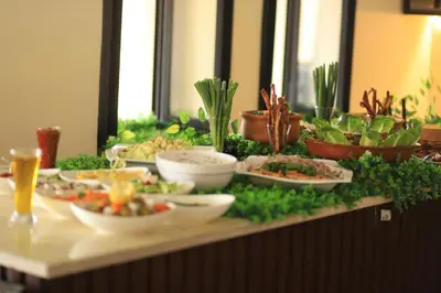 a buffet with bowls of food on a table at Alqalah Restotel فندق ومطعم القلعة in Kerak