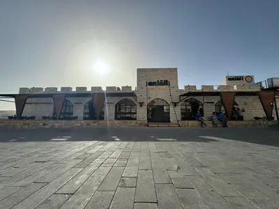 a brick building with the sun in the sky at Alqalah Restotel فندق ومطعم القلعة in Kerak