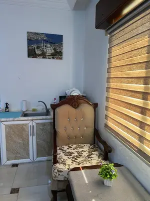 a chair sitting in a kitchen with a window at Jerash Gate in Jerash