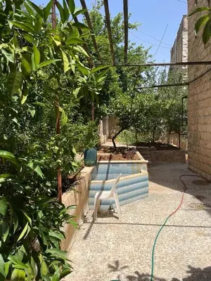 a white chair sitting in front of a pool at L goats house in Wadi Musa
