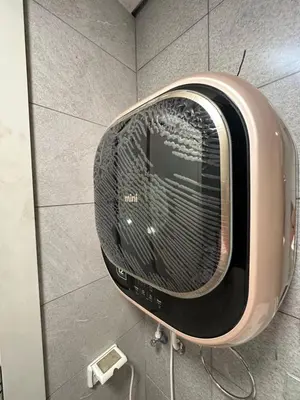 a toaster oven on the wall of a bathroom at central apartment for rent 16 in Umm Uthainah