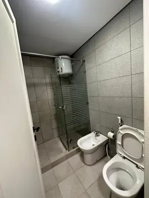 a small bathroom with a toilet and a shower at central apartment for rent 16 in Umm Uthainah