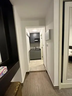 a hallway leading to a room with a kitchen at central apartment for rent 16 in Umm Uthainah