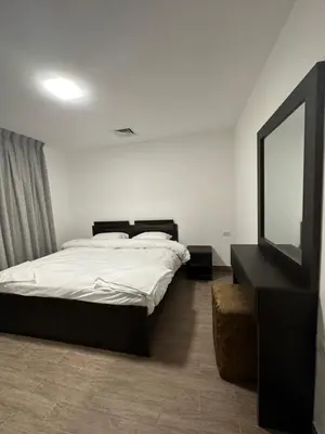 a bedroom with a bed and a mirror and a television at central apartment for rent 17 in Amman