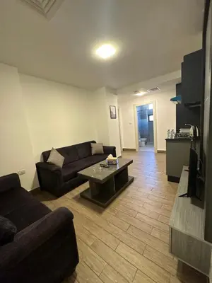 a living room with a couch and a coffee table at central apartment for rent 18 in Umm Uthainah