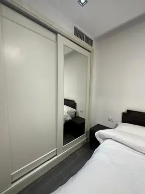 a bedroom with a large glass window with a bed at central apartment for rent 19 in Umm Uthainah
