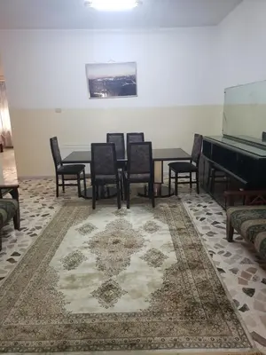 a dining room with a table and chairs and a piano at Alotaibi #6 in Amman