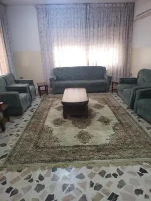 a living room with a couch and a coffee table at Alotaibi #6 in Amman