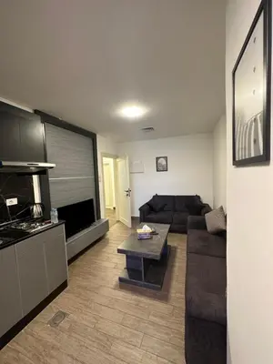 a living room with a couch and a table at central apartment for rent 21 in Amman