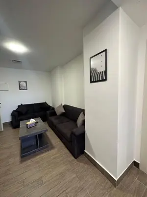 a living room with a couch and a table at central apartment for rent 21 in Amman
