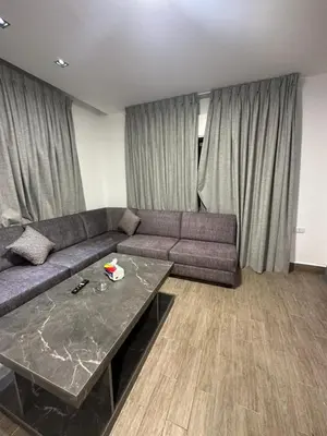a living room with a couch and a table at central apartment for rent 22 in Amman