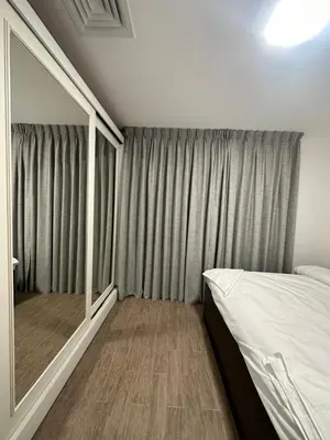 a bedroom with a bed and a large mirror at central apartment for rent 22 in Amman