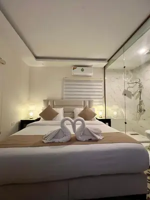 a bedroom with a bed with two towels on it at Eighth Wonders Hotel in Wadi Musa