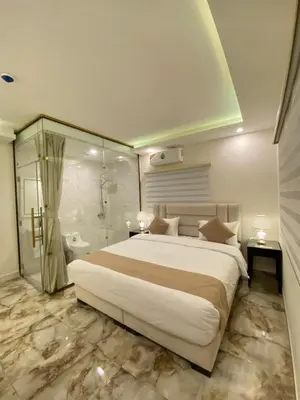 a bedroom with a large bed and a shower at Eighth Wonders Hotel in Wadi Musa