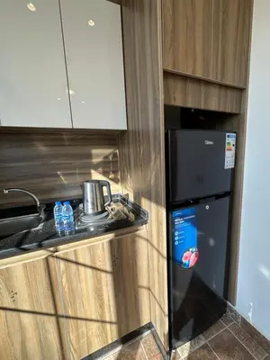 a small kitchen with a counter and a refrigerator at 9 Antica jabalal-lwebdeh in Amman