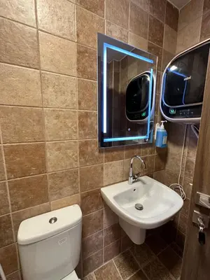 a bathroom with a toilet and a sink and a mirror at 9 Antica jabalal-lwebdeh in Amman