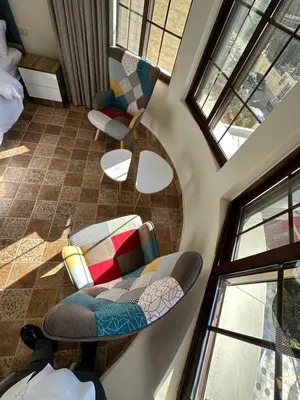 a living room with two chairs and windows at 10 Antica jabalal-lwebdeh in Amman